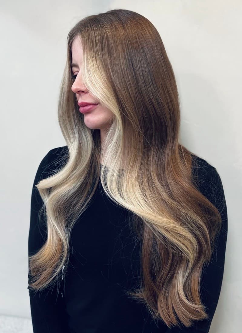 Long brunette hair with a soft blonde face-frame and dimensional lengths